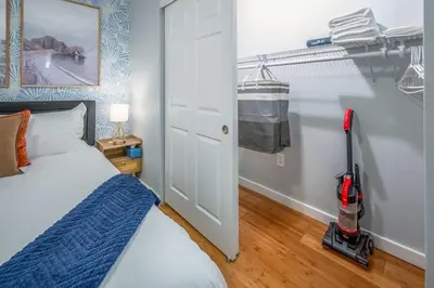a bedroom with a bed and a vacuum in a room at Prime OTR by TQL, Smart TVs, King Bed, Wifi, Sleeps 3ppl, 1st Fl in Cincinnati