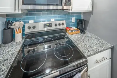 a kitchen with a stove top oven in a kitchen at Prime OTR by TQL, Smart TVs, King Bed, Wifi, Sleeps 3ppl, 1st Fl in Cincinnati