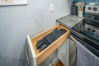 a small kitchen with a stove and a sink at Prime OTR by TQL, Smart TVs, King Bed, Wifi, Sleeps 3ppl, 1st Fl in Cincinnati