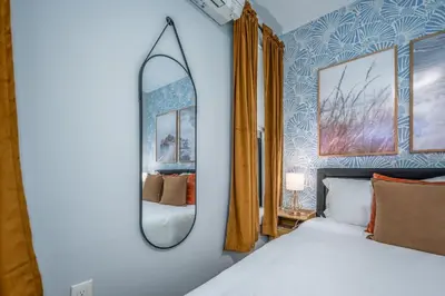 a bedroom with a white bed and a mirror at Prime OTR by TQL, Smart TVs, King Bed, Wifi, Sleeps 3ppl, 1st Fl in Cincinnati