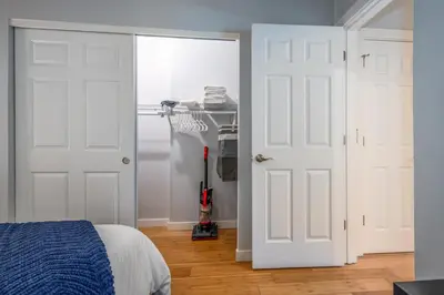 a bedroom with two white doors and a closet at OTR by TQL, Smart TVs, Lux King Bed, Fast Wifi, Sleeps 3ppl, 2nd Fl in Cincinnati