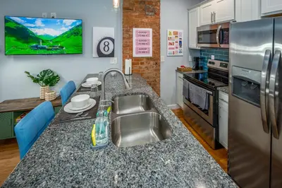 a kitchen with a sink and a counter top at OTR by TQL, Smart TVs, Lux King Bed, Fast Wifi, Sleeps 3ppl, 2nd Fl in Cincinnati