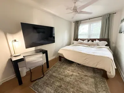 a bedroom with a bed and a tv and a rug at New Listing The Float House at Buckeye Lake in Thornville