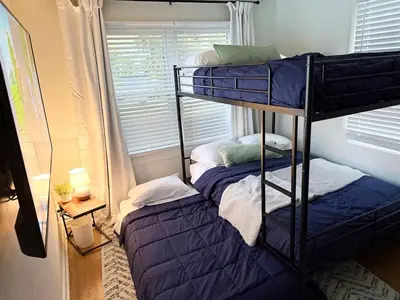 two bunk beds in a room with a window at New Listing The Float House at Buckeye Lake in Thornville