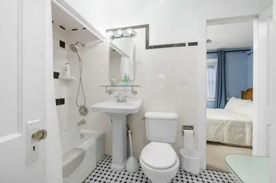 a bathroom with a sink and a toilet and a bath tub at Historic 2 Bdr across from Lakeside Park in Fort Wayne
