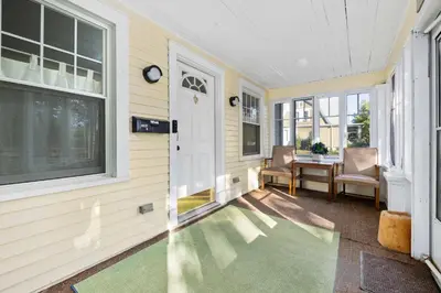 a hallway with a door and a table and chairs at Historic 2 Bdr across from Lakeside Park in Fort Wayne