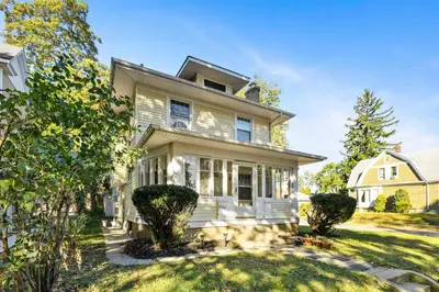 a white house with a yard at Historic 2 Bdr across from Lakeside Park in Fort Wayne