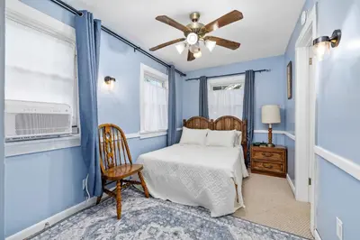 a bedroom with a bed and a ceiling fan at Historic 2 Bdr across from Lakeside Park in Fort Wayne