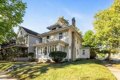a large white house with a large yard at Historic 1 Bdr across from Lakeside Park in Fort Wayne