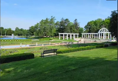 a park with a bench in a park with a fountain at Historic 1 Bdr across from Lakeside Park in Fort Wayne