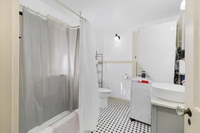 a bathroom with a shower and a sink and a toilet at Historic 1 Bdr across from Lakeside Park in Fort Wayne