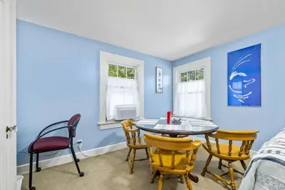 a dining room with a table and chairs at Historic 1 Bdr across from Lakeside Park in Fort Wayne