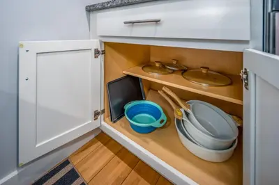 a small kitchen with a sink and a cabinet at OTR by TQL, Lux King Bed, Sleeps 4ppl, Smart TVs, Fast Wifi, 3rd Fl in Cincinnati