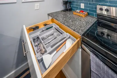 a kitchen with an open drawer next to a stove at OTR by TQL, Lux King Bed, Sleeps 4ppl, Smart TVs, Fast Wifi, 3rd Fl in Cincinnati
