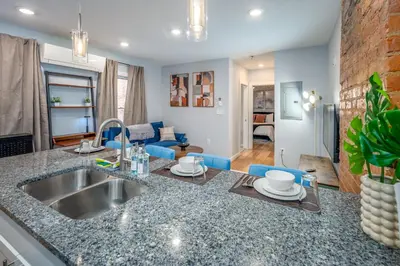 a kitchen with a sink and a living room at OTR by TQL, Lux King Bed, Sleeps 4ppl, Smart TVs, Fast Wifi, 3rd Fl in Cincinnati