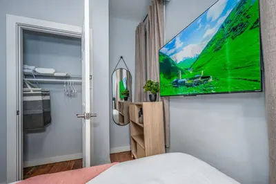 a bedroom with a flat screen tv on a wall at OTR by Findlay, Sleeps 6ppl, King Bed, Private Balcony, 2nd Fl in Cincinnati