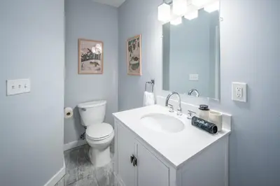 a white bathroom with a toilet and a sink at OTR by Findlay, Sleeps 6ppl, King Bed, Private Balcony, 2nd Fl in Cincinnati