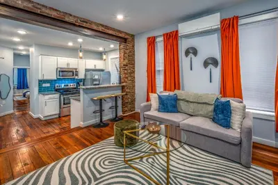 a living room with a couch and a kitchen at OTR by Findlay, Sleeps 6ppl, King Bed, Private Balcony, 2nd Fl in Cincinnati