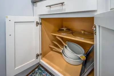 a cupboard with a pot and pans in a kitchen at OTR by Findlay, Sleeps 6ppl, King Bed, Private Balcony, 2nd Fl in Cincinnati