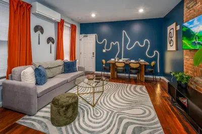 a living room with a couch and a table at OTR by Findlay, Sleeps 6ppl, King Bed, Private Balcony, 2nd Fl in Cincinnati
