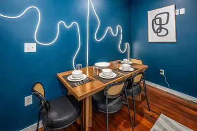 a dining room with a wooden table and chairs at OTR by Findlay, Sleeps 6ppl, King Bed, Private Balcony, 2nd Fl in Cincinnati