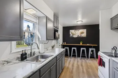 a kitchen with a sink and a counter at 2BR with Private Hot Tub in Parma Heights