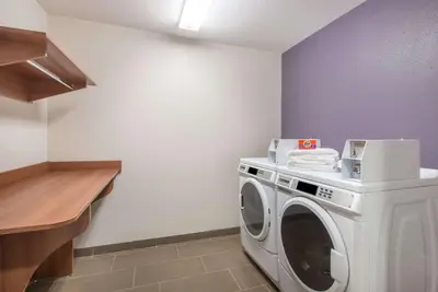 a laundry room with a washing machine and a counter at Microtel Inn & Suites by Wyndham Cadiz in Cadiz