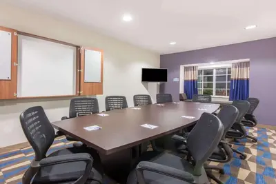 a conference room with a large table and chairs at Microtel Inn & Suites by Wyndham Cadiz in Cadiz