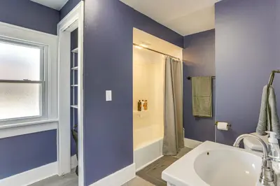 a blue bathroom with a tub and a sink at Walk to Port Clinton Lighthouse Home with Deck! in Port Clinton