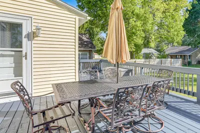 a table with an umbrella and chairs on a deck at Walk to Port Clinton Lighthouse Home with Deck! in Port Clinton