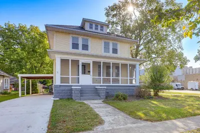 a yellow house with a porch on a street at Walk to Port Clinton Lighthouse Home with Deck! in Port Clinton