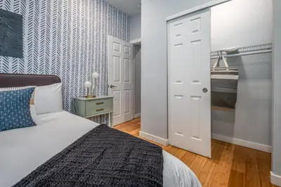 a bedroom with a bed and a closet at OTR by TQL, Private Rooftop, King Beds, Sleeps 8ppl, Wifi in Cincinnati