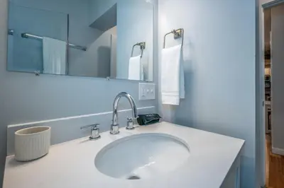 a bathroom with a white sink and a mirror at OTR by TQL, Private Rooftop, King Beds, Sleeps 8ppl, Wifi in Cincinnati