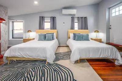 two beds sitting next to each other in a room at OTR by TQL, Private Rooftop, King Beds, Sleeps 8ppl, Wifi in Cincinnati