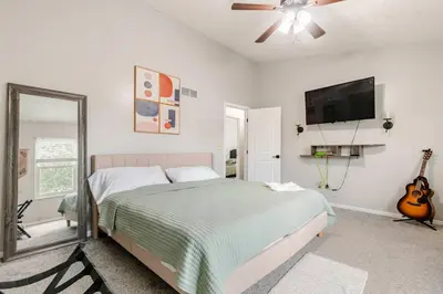 a bedroom with a bed and a flat screen tv at Modern Boho Retreat, in Grove City in Grove City