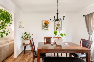a dining room and living room with a table and chairs at Modern Boho Retreat, in Grove City in Grove City