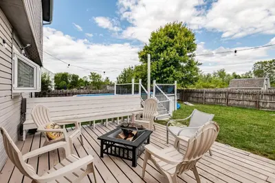 a wooden deck with chairs and a fire pit at Modern Boho Retreat, in Grove City in Grove City