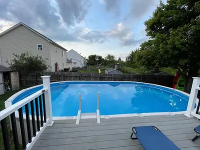 a large blue swimming pool on a wooden deck at Modern Boho Retreat, in Grove City in Grove City