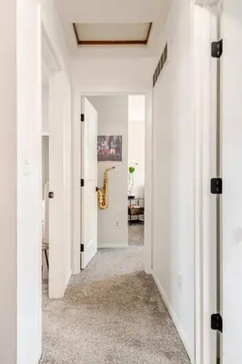 a hallway with white walls and a white ceiling at Modern Boho Retreat, in Grove City in Grove City