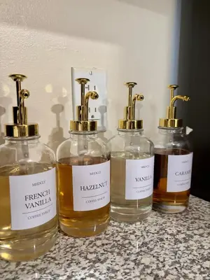 a group of four bottles of whiskey sitting on a counter at Family Home Minutes from Downtown Cincy in Cincinnati