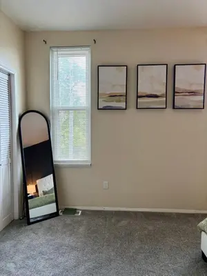 a room with a mirror and three pictures on the wall at Family Home Minutes from Downtown Cincy in Cincinnati