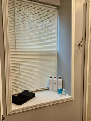 a window with three bottles sitting on a shelf at Family Home Minutes from Downtown Cincy in Cincinnati