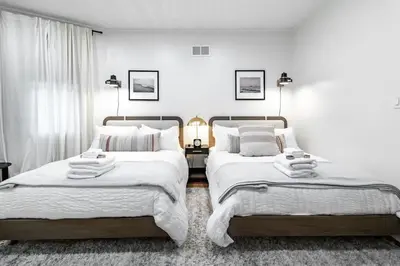 two beds sitting next to each other in a bedroom at Riverfront Retreat - 2 Units - 3BR - Free Parking in Cleveland
