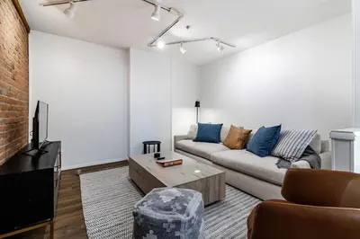a living room with a couch and a tv at Riverfront Retreat - 2 Units - 3BR - Free Parking in Cleveland