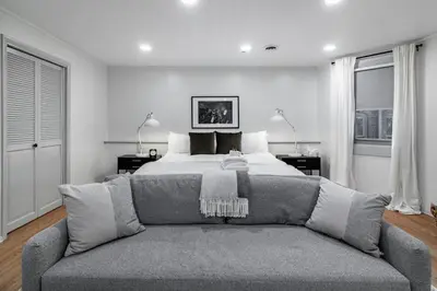 a bedroom with a bed and a couch at Riverfront Retreat - 2 Units - 3BR - Free Parking in Cleveland