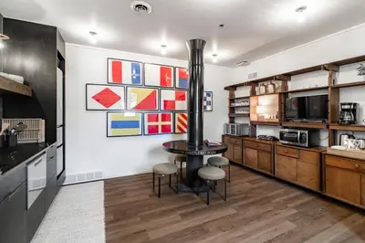 a kitchen with a table and chairs in a room at Riverfront Retreat - 2 Units - 3BR - Free Parking in Cleveland