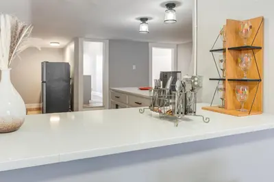 a kitchen with a white counter top and a refrigerator at Walk to Coventry Village Charming Top-Floor Unit! in Cleveland Heights