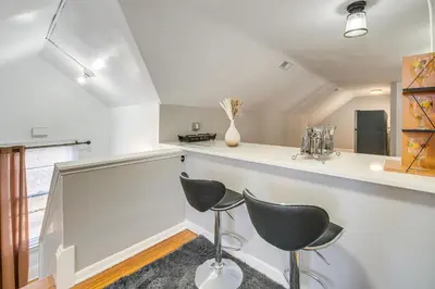 a kitchen with two chairs and a counter at Walk to Coventry Village Charming Top-Floor Unit! in Cleveland Heights