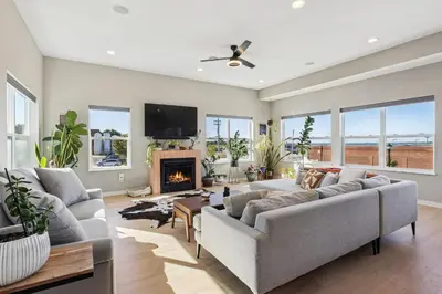 a living room with a couch and a fireplace at Family Fun Near Cedar Point - Rooftop Lake Views in Sandusky