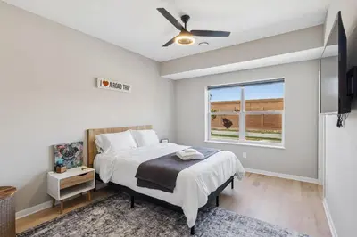 a bedroom with a bed and a ceiling fan at Family Fun Near Cedar Point - Rooftop Lake Views in Sandusky